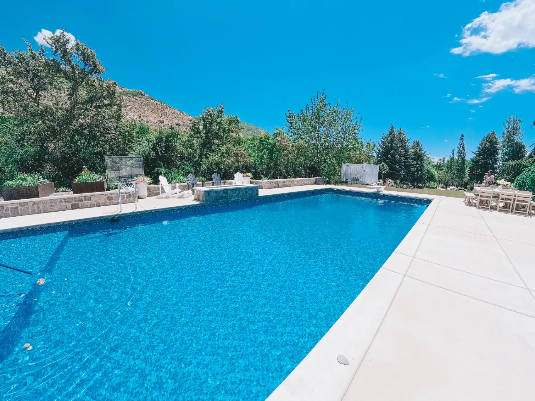 Ogden Utah Mountain-View Vinyl Pool - Barr Pool Builders Large custom vinyl inground swimming pool with mosaic tile, in-pool basketball hoop and Wasatch mountain views in Ogden, Utah by Barr Pool Builders