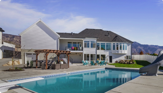 Farmington Backyard Pool Design — Barr Pool Builders Custom backyard vinyl pool design with seating area in Farmington, Utah by Barr Pool Builders