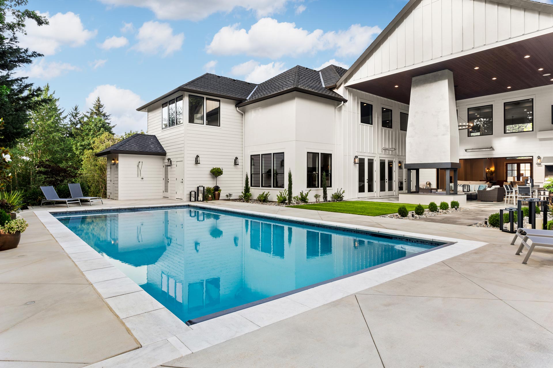 Kaysville Resort-Style Vinyl Pool — Barr Pool Builders Resort-style vinyl swimming pool with expansive patio and lounge seating in Kaysville, Utah by Barr Pool Builders