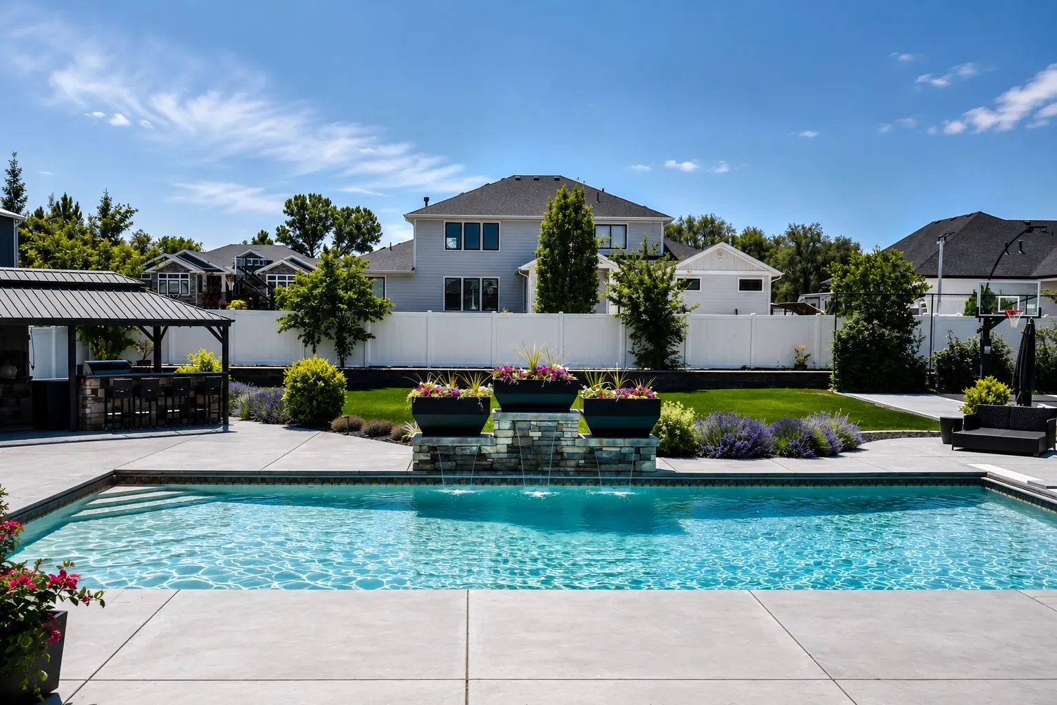 Luxury Syracuse Utah backyard with custom vinyl pool, planter waterfalls, outdoor kitchen and basketball court