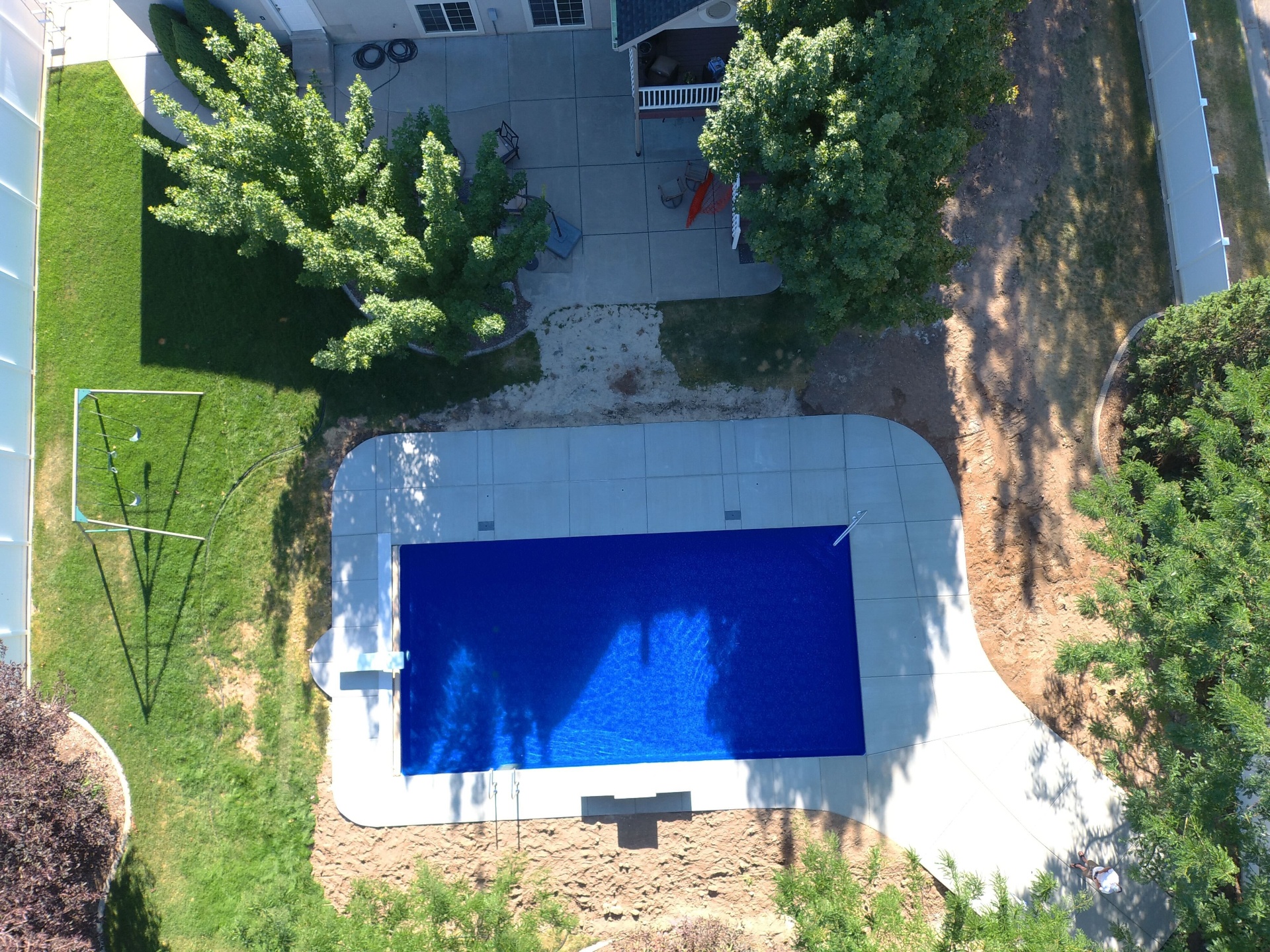 Weber County Modern Vinyl Pool — Barr Pool Builders Modern vinyl liner swimming pool with stone pool deck and clean architectural lines in Weber County, Utah by Barr Pool Builders