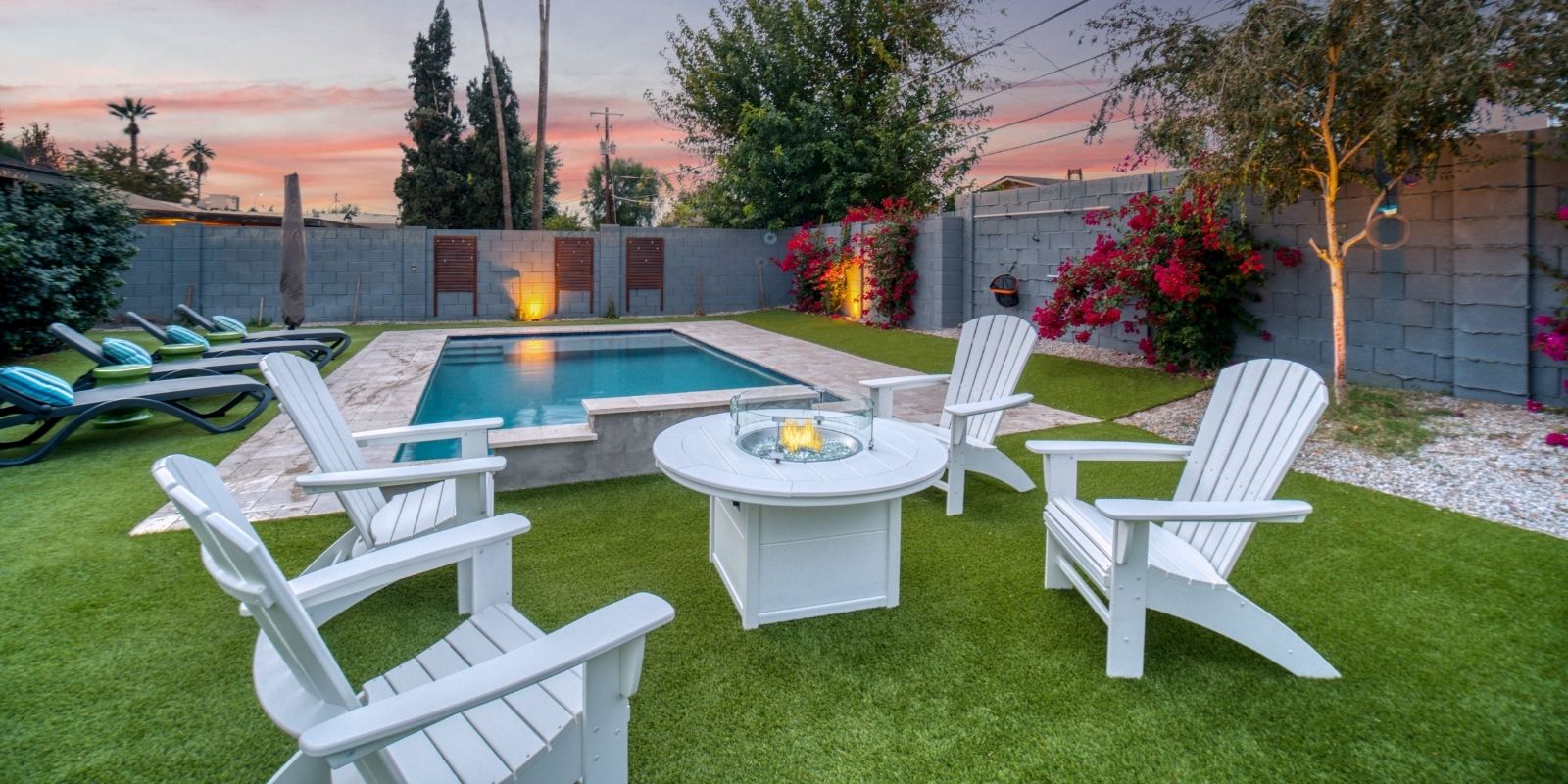 Northern Utah Poolside Firepit Lounge — Barr Pool Builders Backyard vinyl swimming pool with firepit lounge and turf landscaping in Northern Utah by Barr Pool Builders