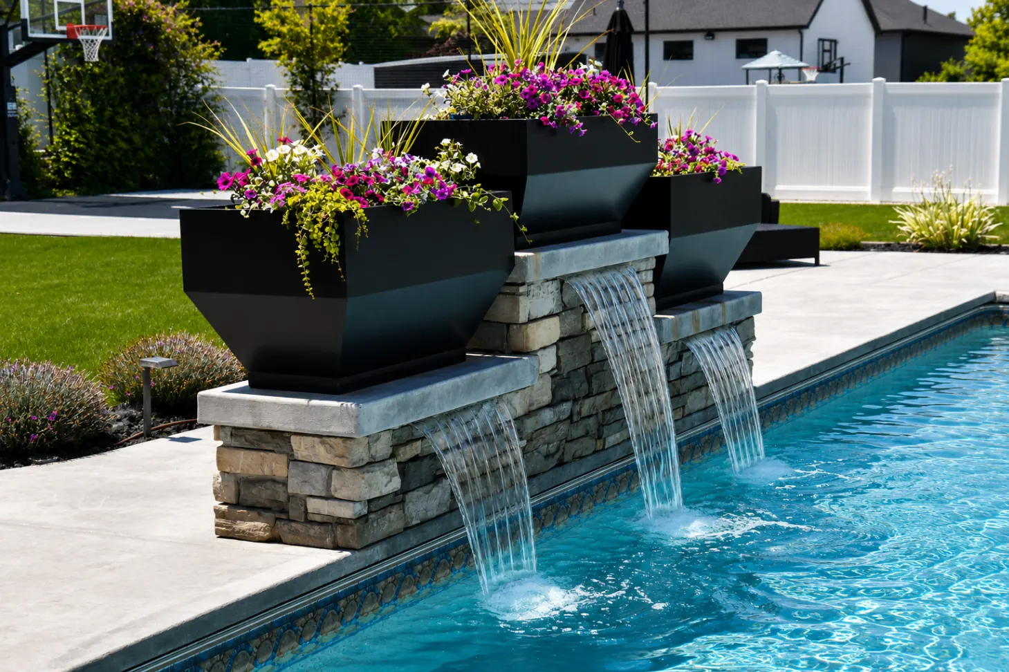 Stacked stone pool water feature with cascading sheer descents and modern planters in Northern Utah